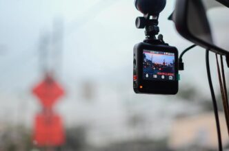 A sleek car interior with a dashcam in a bustling twilight city scene.